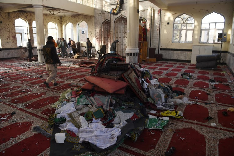 afghan residents inspect the imam zaman shiite mosque the day after a suicide attack during friday evening prayers in kabul on october 21 2017 a strong smell of blood and flesh permeated the imam zaman mosque in kabul on october 21 hours after dozens of shiite worshippers were slaughtered by a suicide bomber during evening prayers broken glass and dust covered the red carpet soaked in the blood of the men women and children who had been praying on friday when the attacker blew himself up causing carnage in the cavernous prayer hall afp photo wakil kohsar