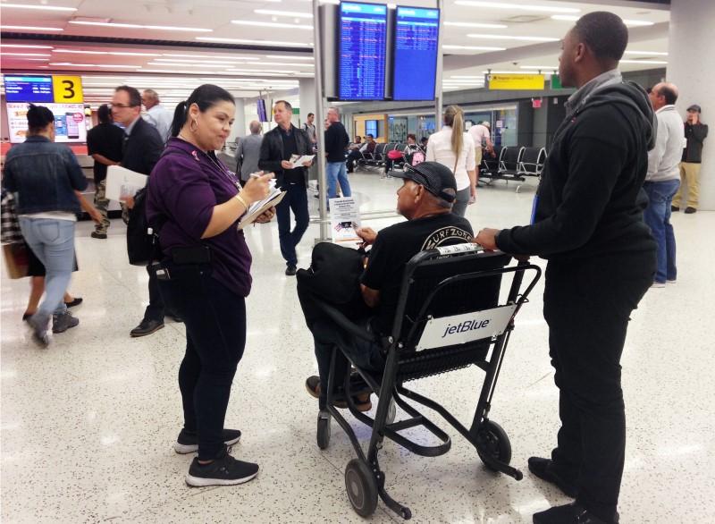 emily pagan a new york state government official greets and help orients people arriving from puerto rico and the u s virgin islands at john f kennedy international airport in new york u s october 19 2017 photo taken october 19 2017 reuters jonathan allen