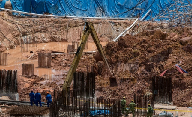 rescue workers search for victims of a landslide at a construction site in tanjung bungah on the north of penang photo afp rescue workers search for victims of a landslide at a construction site in tanjung bungah on the north of penang photo afp