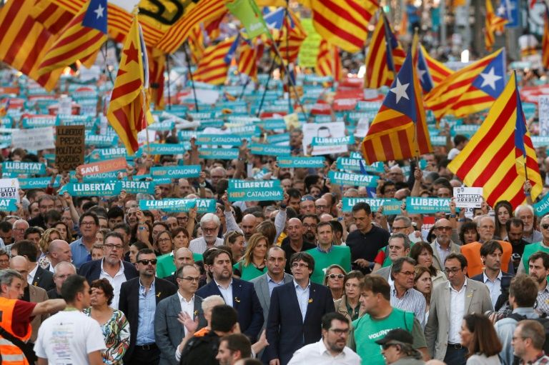 catalan regional vice president and chief of economy and finance oriol junqueras and catalan regional president carles puigdemont attend a demonstration in barcelona photo afp