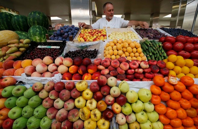 a vendor sells vegetables and fruits at the city market photo reuters