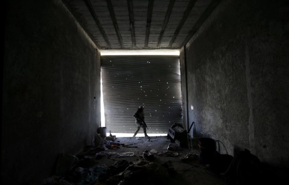 a free syrian army fighter walks as he holds his weapon in a damaged shop in the town of tadef aleppo governorate syria oct 23 2017 syrian video journalist waad al kateab on monday won britain 039 s prestigious rory peck award for her horrific footage inside an aleppo hospital in the aftermath of a deadly bombing her footage quot shows us so powerfully the horrors of war quot which is still ongoing photo reuters