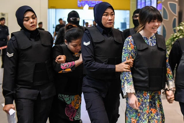 vietnamese defendant doan thi huong r and indonesian defendant siti aishah 2nd l are escorted by police personnel at the low cost carrier kuala lumpur international airport 2 klia2 in sepang during a visit to the scene of the murder as part of the shah alam high court trial process on october 24 2017 for their alleged role in the assassination of kim jong nam indonesian siti aisyah 25 and huong 28 have been charged with the murder of kim jong nam the estranged half brother of north korean leader kim jong un at kuala lumpur international airport 2 klia2 in february photo afp vietnamese defendant doan thi huong r and indonesian defendant siti aishah 2nd l are escorted by police personnel at the low cost carrier kuala lumpur international airport 2 klia2 in sepang during a visit to the scene of the murder as part of the shah alam high court trial process on october 24 2017 for their alleged role in the assassination of kim jong nam indonesian siti aisyah 25 and huong 28 have been charged with the murder of kim jong nam the estranged half brother of north korean leader kim jong un at kuala lumpur international airport 2 klia2 in february photo afp