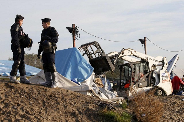 french police secure the area as a bulldozer tears down makeshift shelters during the dismantlement of the camp called the quot jungle quot in calais france october 27 2016 photo reuters