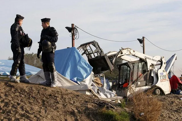 french police secure the area as a bulldozer tears down makeshift shelters during the dismantlement of the camp called the quot jungle quot in calais france october 27 2016 photo reuters french police secure the area as a bulldozer tears down makeshift shelters during the dismantlement of the camp called the quot jungle quot in calais france october 27 2016 photo reuters