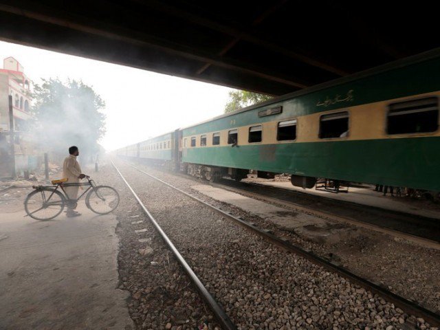 a man waits to cross a portion of track once shared with the disused karachi circular railway line in karachi pakistan may 24 2017 photo reuters
