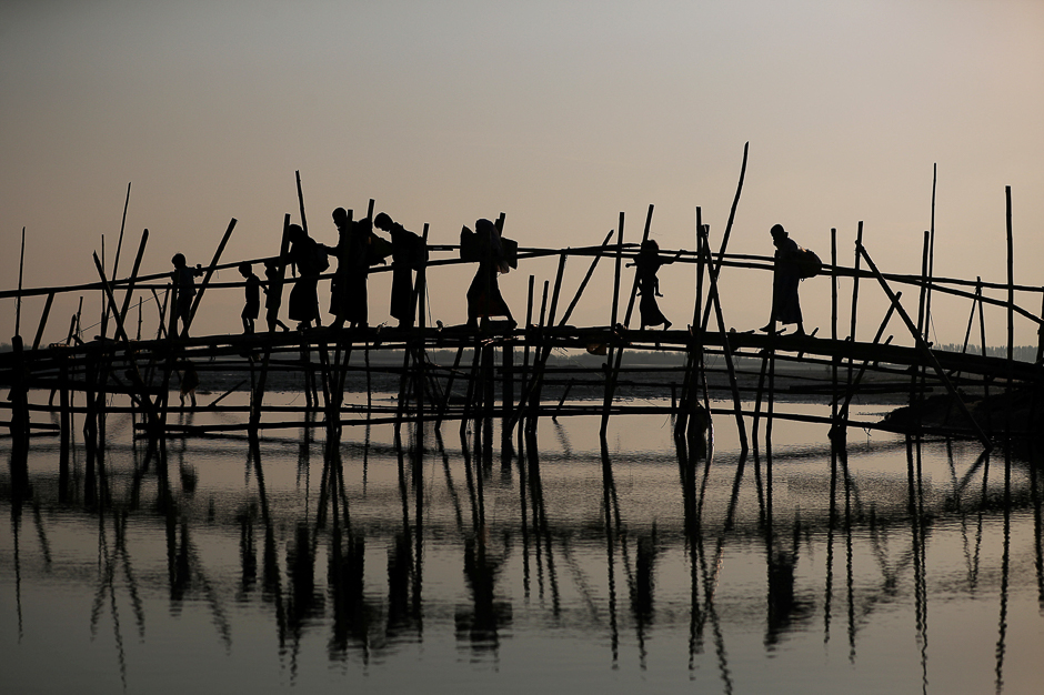 rohingya refugees cross a bamboo bridge as they arrive at a port after crossing from myanmar in teknaf bangladesh photo reuters