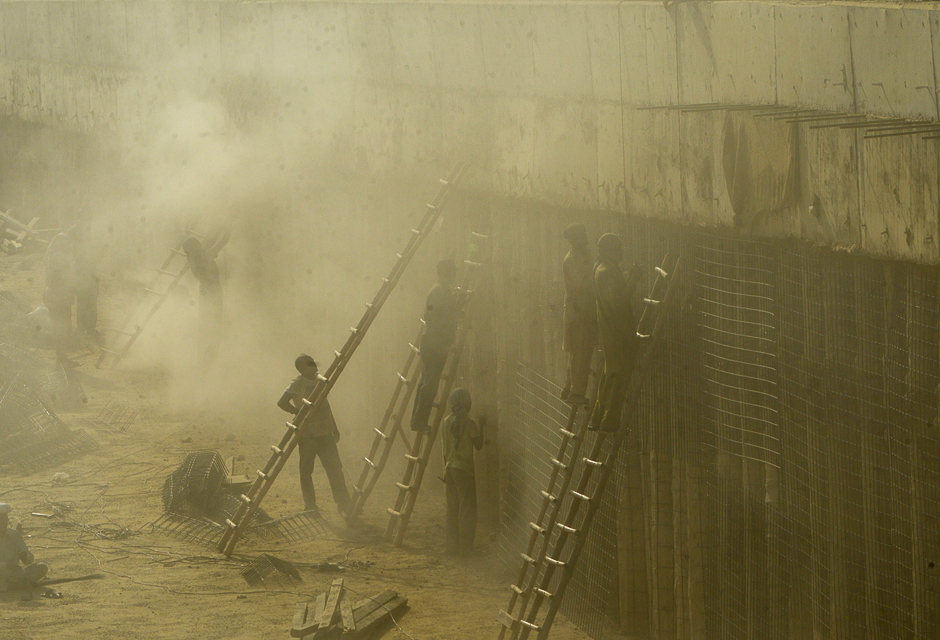 labourers works on a contruction site in lahore photo afp file