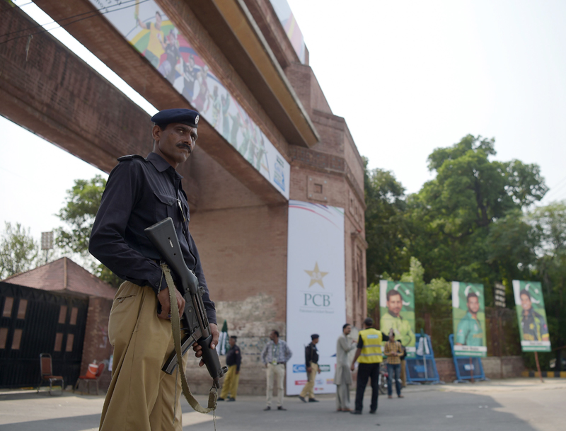 policeman stands guard at the main entrance of the gaddafi cricket stadium in lahore on september 12 2017 photo afp