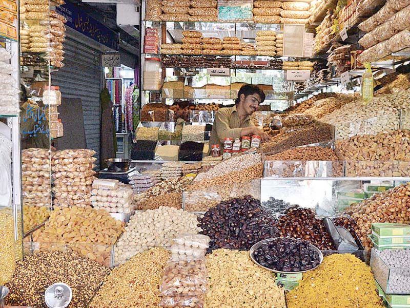a shopkeeper sells dry fruits in islamabad photo app