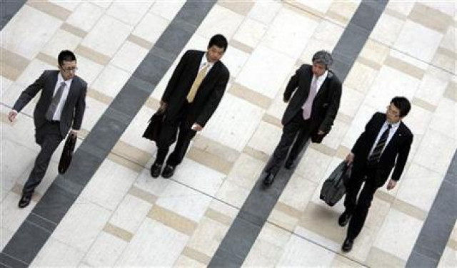 businessmen walk on a street photo reuters businessmen walk on a street photo reuters