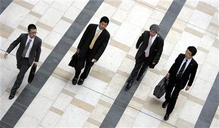 businessmen walk on a street photo reuters