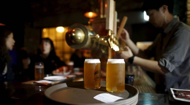 an employee pours a glass of craft beer photo reuters