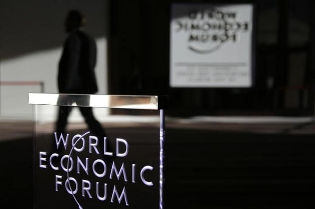 a man passes a logo during the annual meeting of the world economic forum wef in davos switzerland january 22 2016 photo reuters