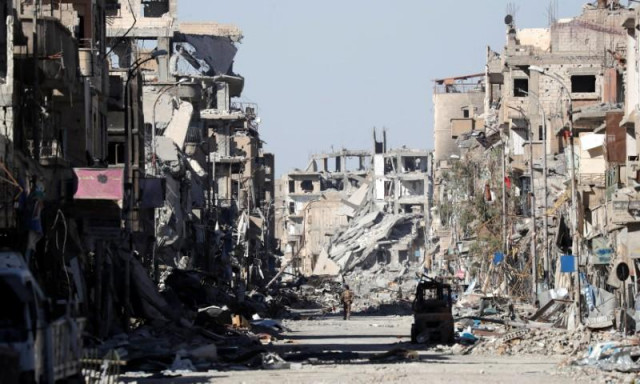 a fighter of syrian democratic forces stands amidst the ruins of buildings near the clock square in raqqa photo reuters a fighter of syrian democratic forces stands amidst the ruins of buildings near the clock square in raqqa photo reuters