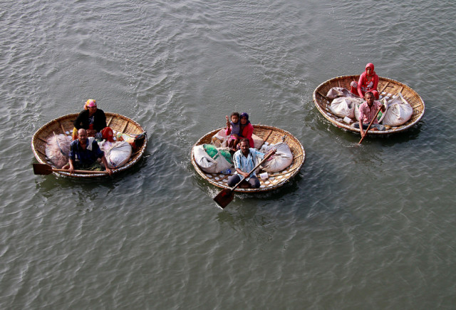 fishermen paddle their boats as they carry their family members in the waters of vembanad lake in kochi india photo reuters fishermen paddle their boats as they carry their family members in the waters of vembanad lake in kochi india photo reuters