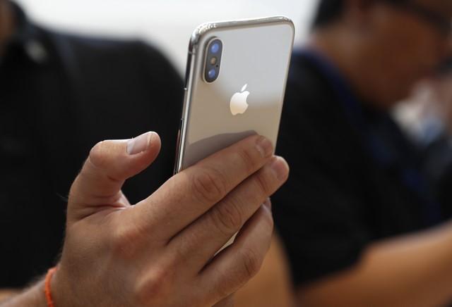 an attendee checks out a new iphone x during an apple launch event in cupertino california us september 12 2017 photo reuters