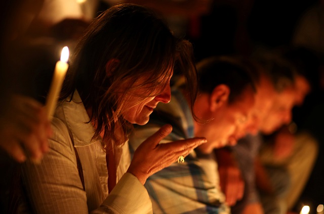 a woman reacts as people place candles outside the instituto politecnico a technical high school where the five argentine citizens who were killed in the truck attack in new york on october 31 went to school in rosario argentina november 1 2017 photo reuters