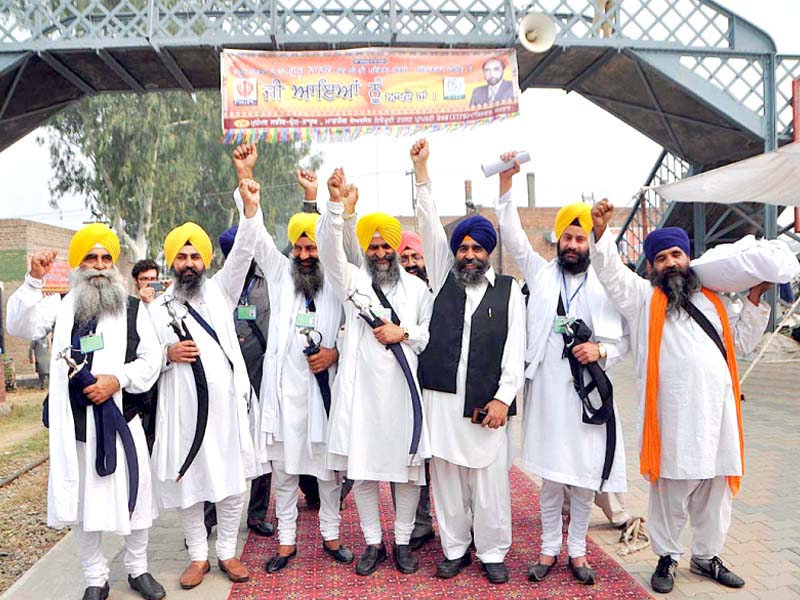 a group of sikh yatrees cheer upon their arrival at wahga border photo app