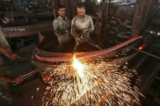 labourers work inside an iron factory photo reuters