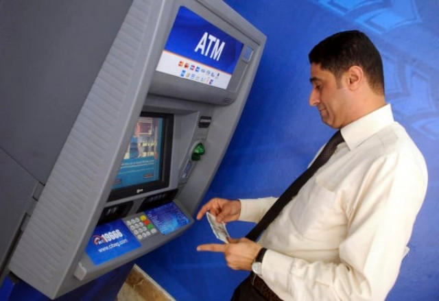 a man withdraws money from an atm machine photo reuters