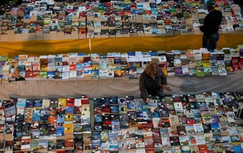 a customer takes a book in a bookstore photo reuters