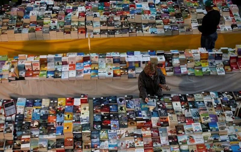 a customer takes a book in a bookstore photo reuters a customer takes a book in a bookstore photo reuters