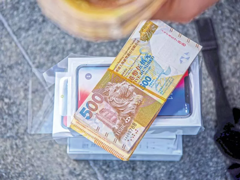 cash belonging to a reseller is placed over a pile of iphone xs near an apple store in hong kong on saturday photo afp cash belonging to a reseller is placed over a pile of iphone xs near an apple store in hong kong on saturday photo afp
