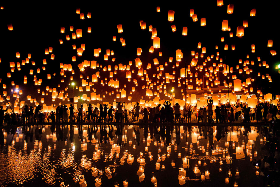 a crowd releases lanterns into the air as they celebrate the yee peng festival also known as the festival of lights in chiang mai photo afp