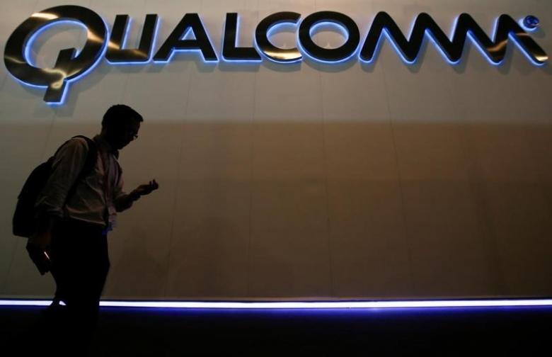 a man walks past qualcomm stand while attending the mobile world congress in barcelona march 3 2015 photo reuters