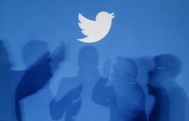 the shadows of people holding mobile phones are cast onto a backdrop projected with the twitter logo in this illustration picture taken in warsaw september 27 2013 photo reuters