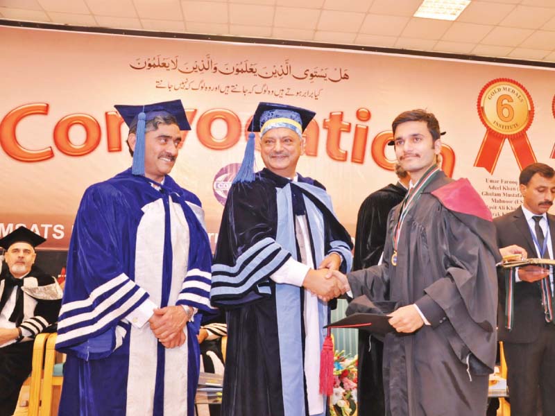 a student receives his degree photo express