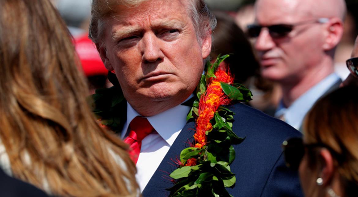 us president donald trump sports a flower lei he was given as he and first lady melania trump arrive aboard air force one at hickam air force base photo reuters