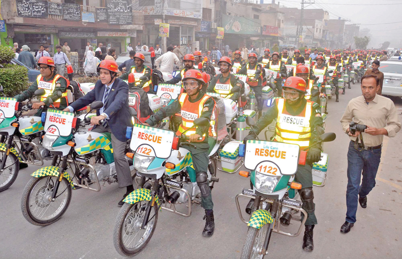 rescue 1122 officials holding a rally after inauguration of motorcycle ambulance service photo ppi