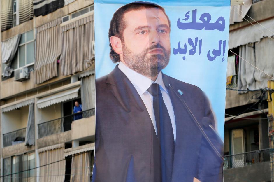 a poster depicting lebanon 039 s prime minister saad al hariri who has resigned from his post hangs along a street in the mainly sunni beirut neighbourhood of tariq al jadideh in beirut lebanon november 6 2017 the arabic on the poster reads quot with you forever quot photo reuters