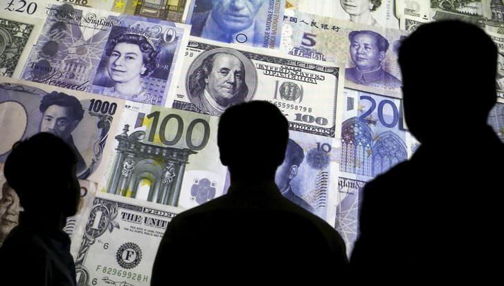 people are silhouetted against a backdrop projected with the picture of various currencies of money in this illustration taken april 4 2016 photo reuters