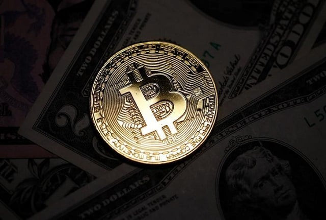 a bitcoin and dollar notes are seen in this illustration picture taken september 27 2017 photo reuters a bitcoin and dollar notes are seen in this illustration picture taken september 27 2017 photo reuters