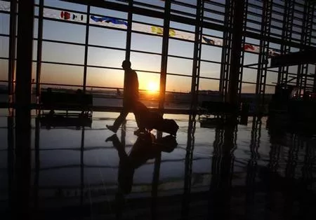 a traveller walks to his flight photo reuters a traveller walks to his flight photo reuters