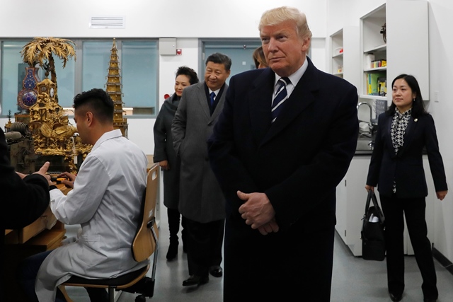 us president donald trump 2nd r tours the conservation scientific laboratory of the forbidden city with china 039 s president xi jinping 3rd l and his wife peng liyuan 2nd l in beijing on november 8 2017 photo afp