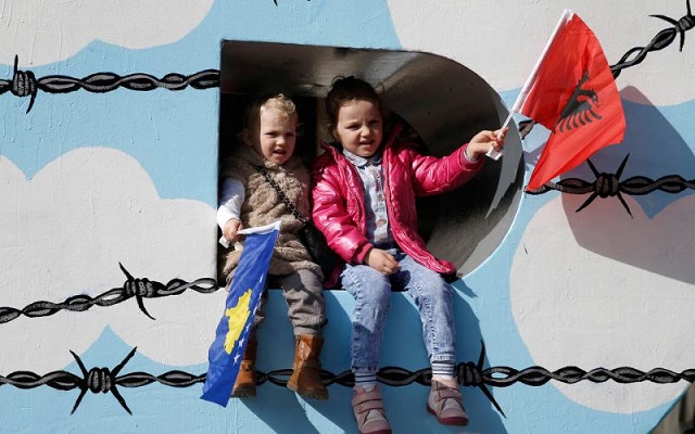 children wave albanian r and kosovar flags on the newborn monument during a celebration marking the eighth anniversary of kosovo 039 s declaration of independence from serbia in pristina february 17 2016 photo reuters