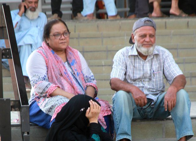 aged people sitting on the stairs waiting for their turn at a biometric verification centre photo athar khan