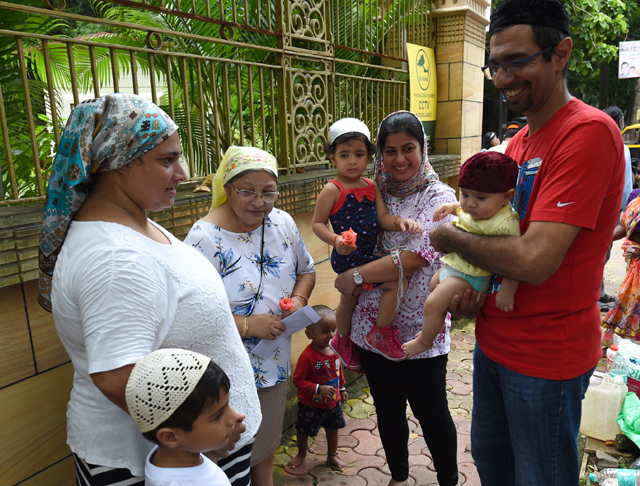 this shows a newborn parsi child being introduced to family friends outside a fire temple after offering prayers in mumbai photo afp