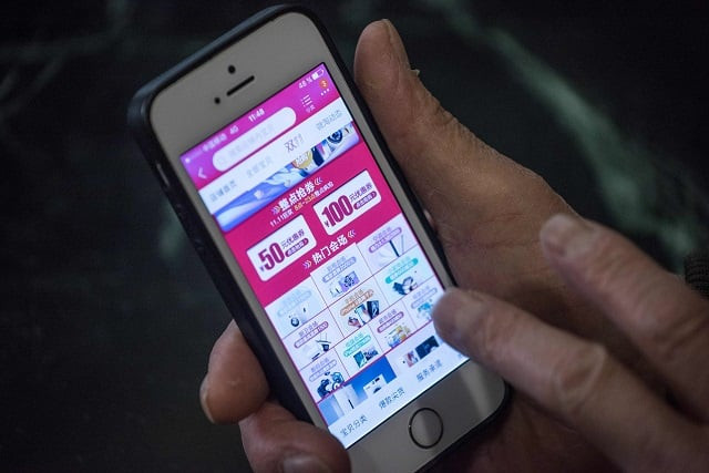 a man looks at a chinese online store 039 s website on his smartphone in beijing on november 11 2017 china 039 s smartphone masses splurged billions of dollars in an e commerce bonanza on november 11 as consumers rushed to snap up bargains on quot double 11 quot billed as the world 039 s biggest one day online shopping festival photo afp a man looks at a chinese online store 039 s website on his smartphone in beijing on november 11 2017 china 039 s smartphone masses splurged billions of dollars in an e commerce bonanza on november 11 as consumers rushed to snap up bargains on quot double 11 quot billed as the world 039 s biggest one day online shopping festival photo afp
