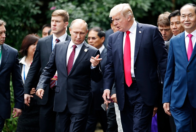 us president donald trump r and russia 039 s president vladimir putin chat as they walk together to take part in the quot family photo quot during the asia pacific economic cooperation apec leaders 039 summit in the central vietnamese city of danang on november 11 2017 photo afp