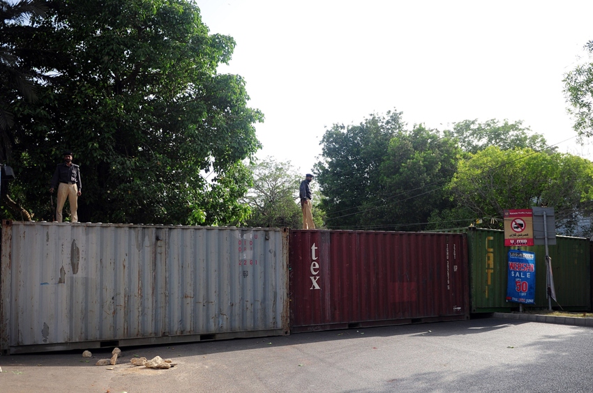 policemen stand guard on containers placed by authorities in front of the british consulate in karachi on june 3 2014 following the arrest of altaf hussain in london photo afp