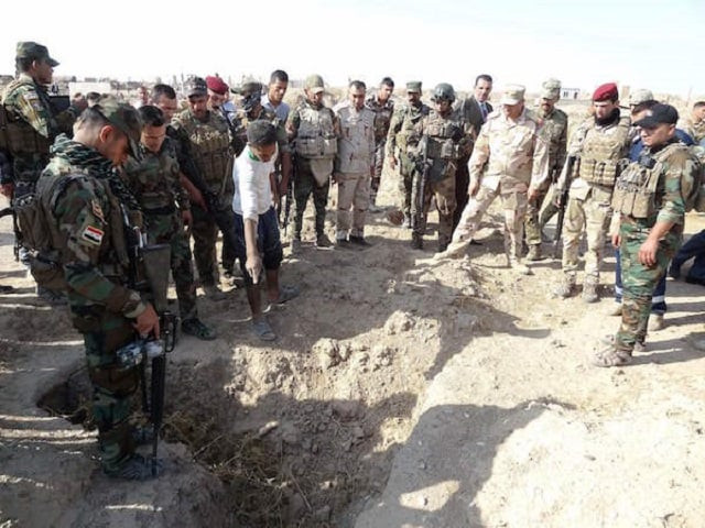 iraqi forces search the site of a suspected mass grave containing the remains of victims of the islamic state group near the former al bakara military base on november 11 2017 south west of hawija photo afp iraqi forces search the site of a suspected mass grave containing the remains of victims of the islamic state group near the former al bakara military base on november 11 2017 south west of hawija photo afp