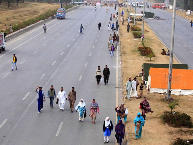 commuters forced to walk on foot on the faizabad interchange due to tly protests photo inp