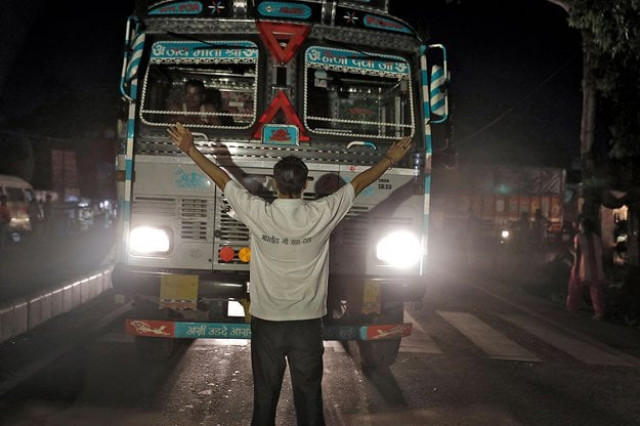 a member of the bhartiya gau raksha dal cow vigilante group raises his arms to stop a truck at a roadblock set up in the northern indian city of chandigarh in early july photo reuters a member of the bhartiya gau raksha dal cow vigilante group raises his arms to stop a truck at a roadblock set up in the northern indian city of chandigarh in early july photo reuters
