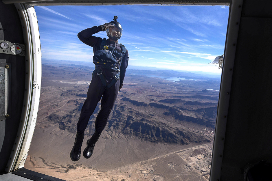 a member of the air force 039 s wings of blue parachute demonstration team salutes as he jumps out of an aircraft during the opening ceremony of aviation nation 2017 nellis air and space expo at nellis air force base nev photo reuters