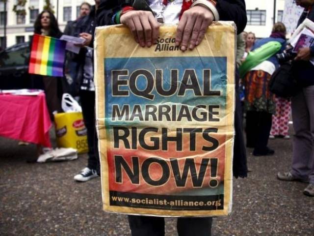 a gay rights activist holds a placard during a rally supporting same sex marriage in sydney photo reuters